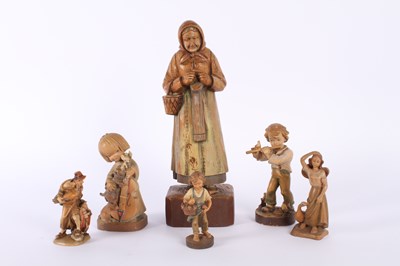 Lot 692 - A collection of vintage wooden figurines, some...