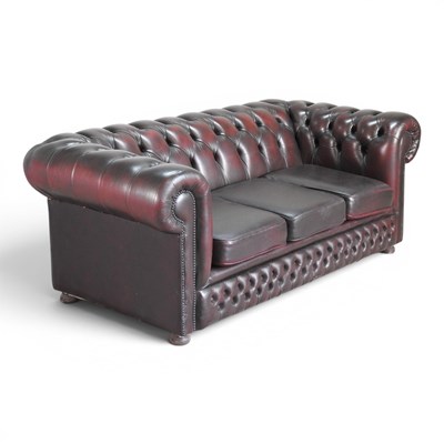 Lot 215 - A modern maroon upholstered chesterfield sofa,...