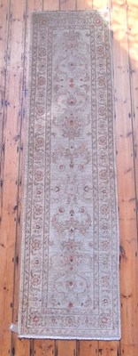 Lot 563 - A Persian style cream runner rug, 311 x 81cm