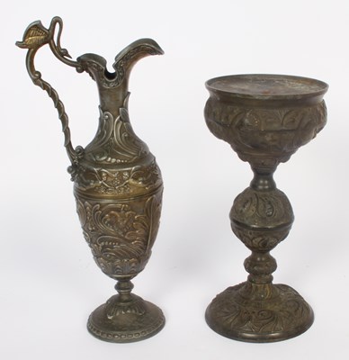 Lot 764 - A repousse decorated spelter ewer and candlestick