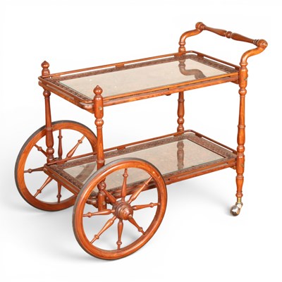 Lot 505 - An Eastern carved hardwood drinks trolley