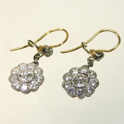 Lot 18 - A pair of unmarked two colour diamond cluster earrings