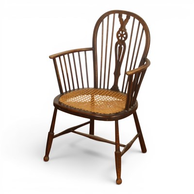 Lot 609 - A beech wheelback armchair, with a caned seat