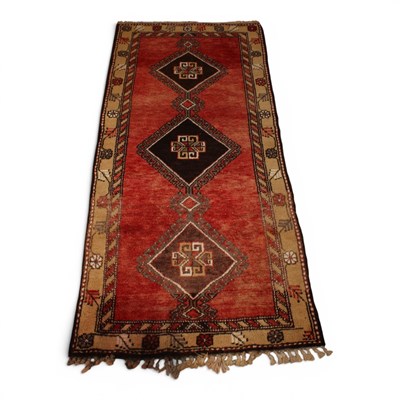 Lot 510 - A Turkish woollen runner, with three central...