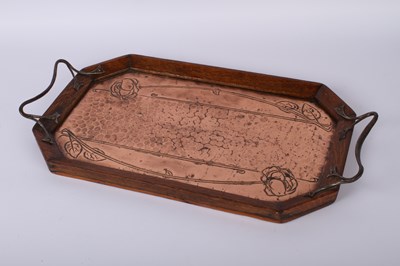 Lot 221 - An Arts and Crafts hammerbeaten copper and oak...