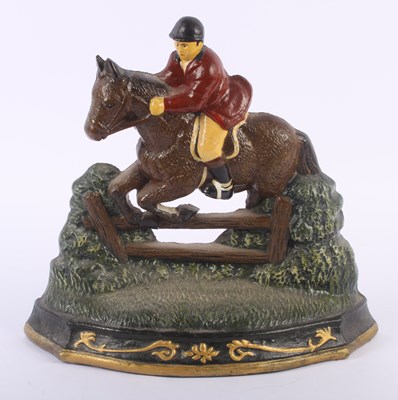 Lot 695 - A painted cast iron door stop, in the form of...