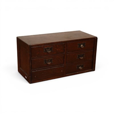 Lot 630 - A six-drawer oak table filing cabinet, with...