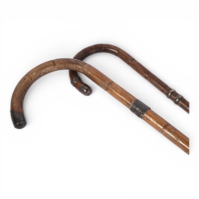 Lot 247 - Two wooden walking sticks with crook handles,...