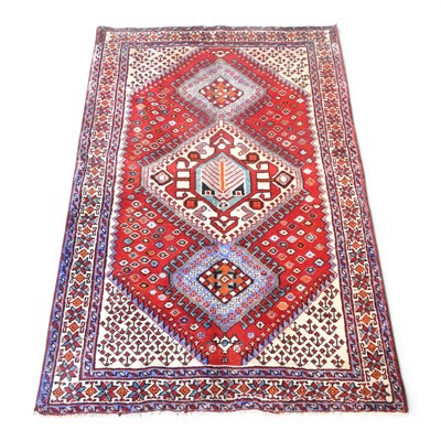 Lot 275 - A Persian rug, with three central hooked...