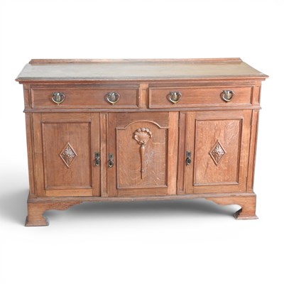 Lot 176 - An Edwardian oak sideboard, on shaped bracket...