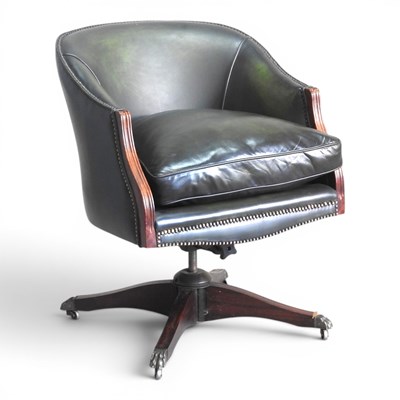 Lot 90 - A green leather upholstered swivel desk chair,...