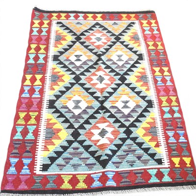 Lot 49 - A Persian kilim rug, with hooked medallions,...