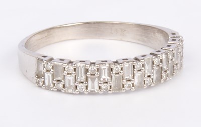 Lot 18 - A 14 carat white gold diamond half hoop...