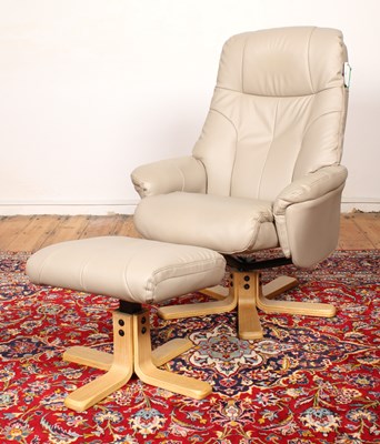 Lot 611 - A pale leather upholstered swivel armchair and...