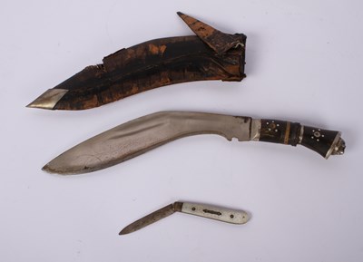 Lot 82 - A kukri, having a leather sheath, together...
