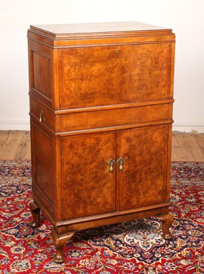 Lot 614 - An early 20th century burr walnut drinks cabinet