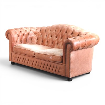 Lot 214 - A tan leather chesterfield sofa, with an...