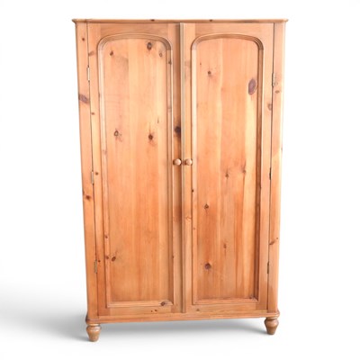 Lot 412 - A pine double wardrobe, on turned feet