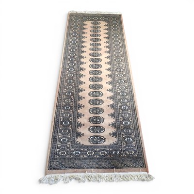 Lot 568 - A Bokara woollen runner, 254 x 80cm