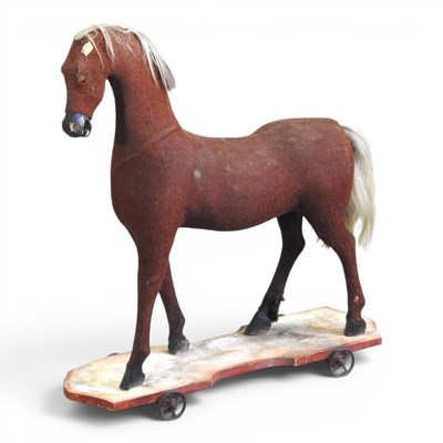 Lot 85 - An early 20th century toy pull along horse