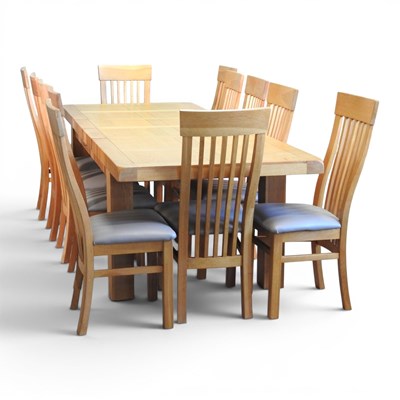 Lot 562 - A large modern light oak extending dining...