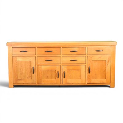 Lot 564 - A large modern light oak sideboard, containing...