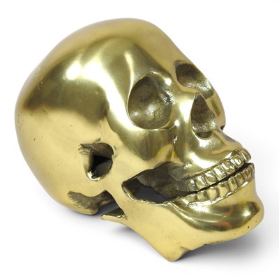 Lot 738 - A cast metal model of a skull, 22cm long