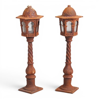 Lot 128 - A pair of rusted metal garden lamp posts, with...