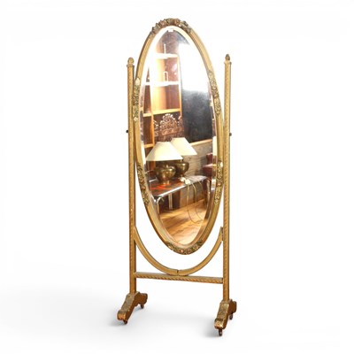 Lot 556 - A floral relief decorated cheval mirror