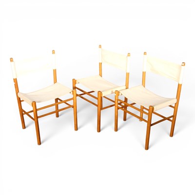 Lot 606 - A set of three beech and white canvas chairs,...