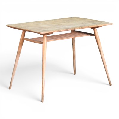 Lot 141 - A 1960s Ercol light elm dining table, on...