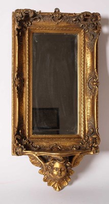 Lot 557 - A Rococo-style wall mirror with gilt frame and...