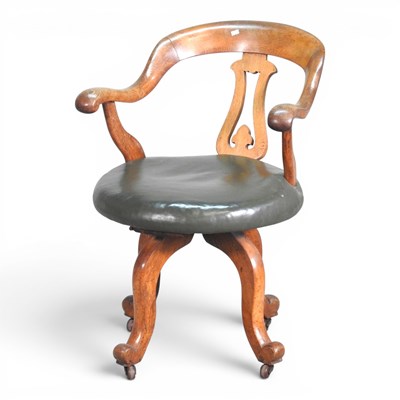Lot 129 - An Edwardian oak revolving desk chair, with a...