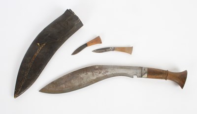 Lot 126 - A Kukri knife in a leather sheath