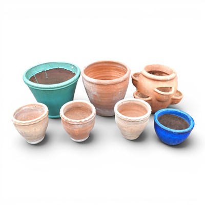 Lot 650 - A collection of glazed garden pots, highest...