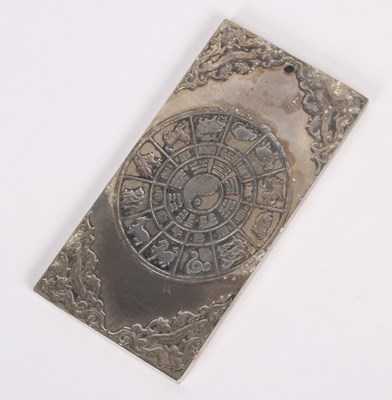 Lot 107 - A Chinese relief decorated white metal ingot