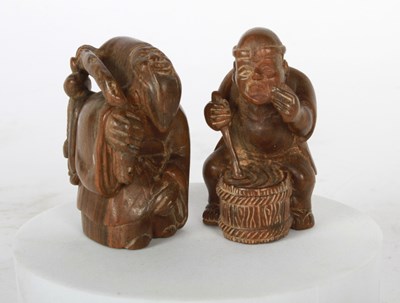 Lot 103 - Two Japanese figural carved wood netsukes,...
