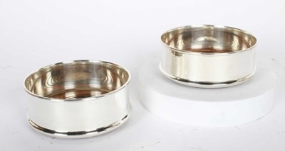 Lot 84 - A pair of silver plated wine coasters