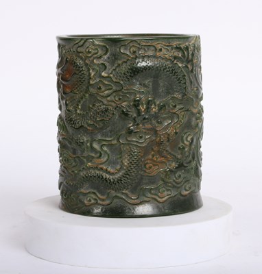 Lot 245 - A Chinese carved jade coloured hardstone brush...