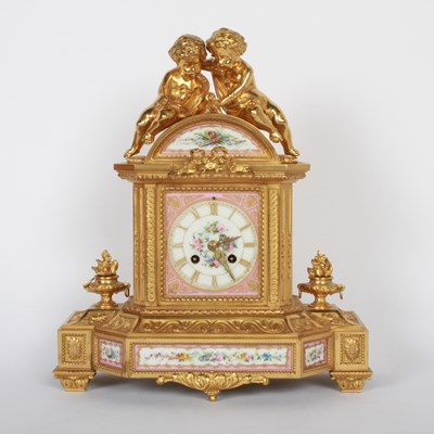Lot 157 - A French ormolu mantel clock, inset with pink...