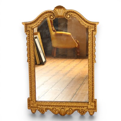 Lot 257 - A Neoclassical gilt wall mirror, having a...