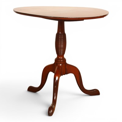 Lot 574 - A Regency mahogany low circular tripod...