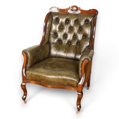 Lot 475 - A green leather button upholstered carved...
