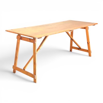 Lot 581 - A folding pine trestle table