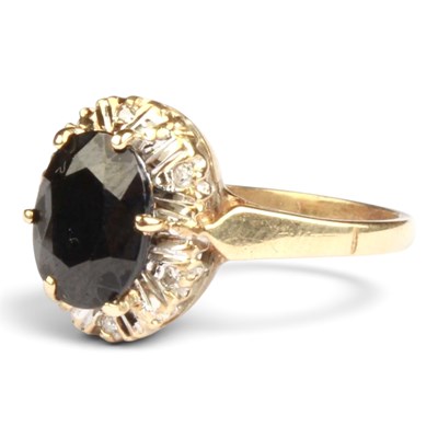 Lot 159 - A 9 carat sapphire and diamond cluster ring, 2....