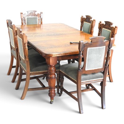 Lot 255 - An Edwardian oak wind out extending dining...