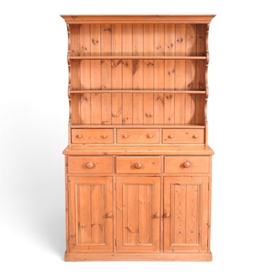 Lot 221 - A modern pine dresser, with a boarded back, on...