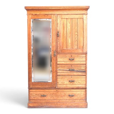 Lot 321 - An Edwardian pitch pine combination wardrobe,...