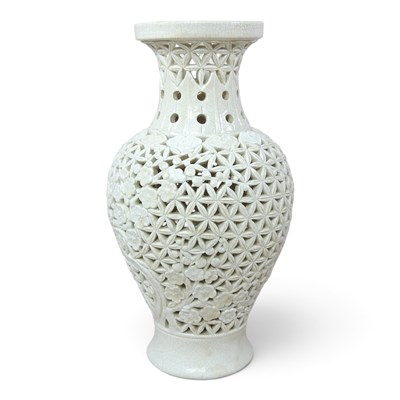 Lot 77 - An oriental white glazed pottery reticulated...