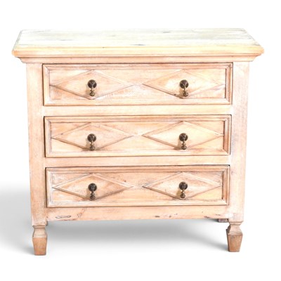 Lot 523 - A limed hardwood chest of drawers, with...